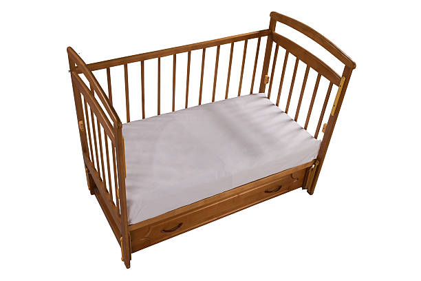 istock Wooden cot with matress isolated on white background 511618541