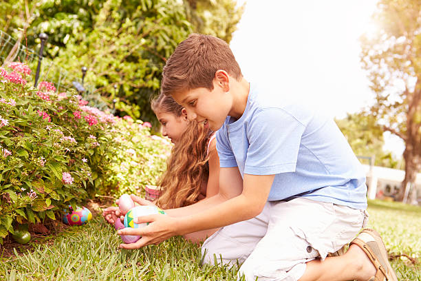 istock Two Children Having Easter Egg Hunt In Garden 511618625