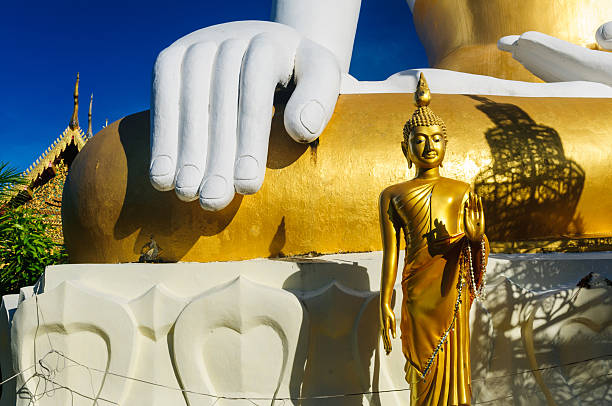 istock Large and small Buddha statues at Wat Doi Kham 511618927