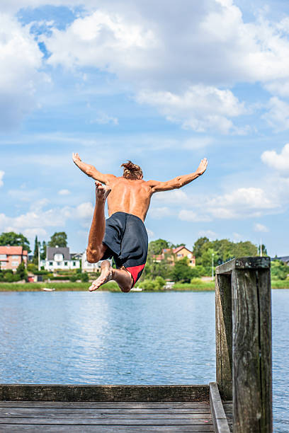istock Man jumping into the water 511621195