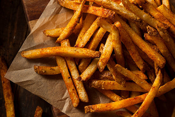 Cajun Seasoned French Fries Cajun Seasoned French Fries with Organic Ketchup crunchy stock pictures, royalty-free photos & images