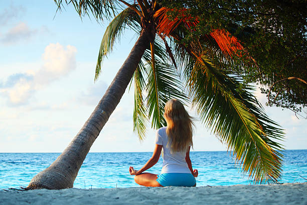 istock yoga woman under palm 511623009