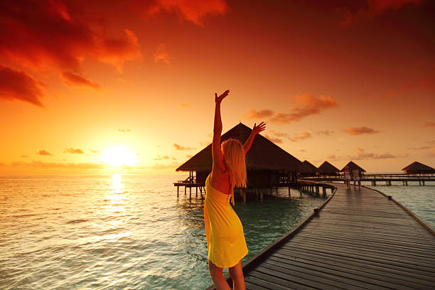 istock woman in a dress on maldivian sunset 511623049