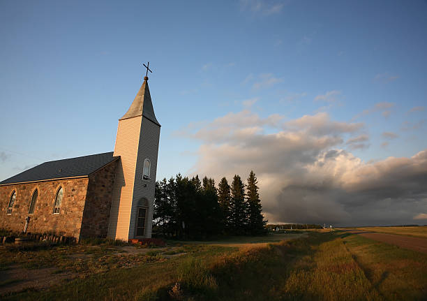 istock Thunderhead clouds forming behind a country church 511623291