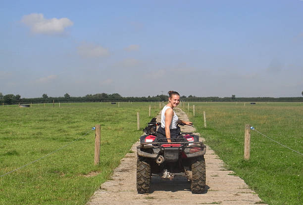 istock Young girl driving a farm quad bike 511643203
