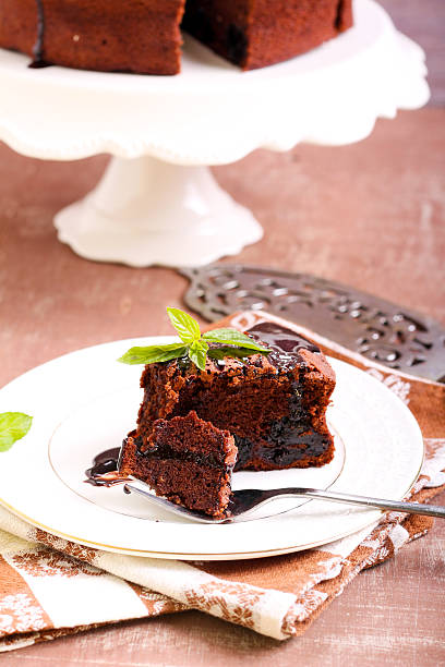 Prune and chocolate torte Prune and chocolate torte, selective focus sunken cake stock pictures, royalty-free photos & images