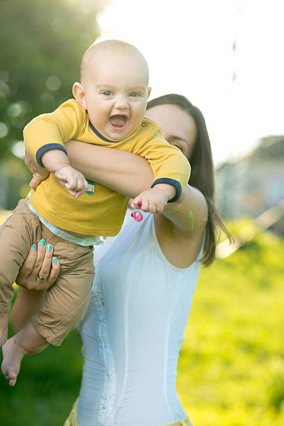 istock Mom throws baby in her arms up 511643721