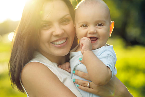 istock Happy mother holding a young son sunlight 511643801