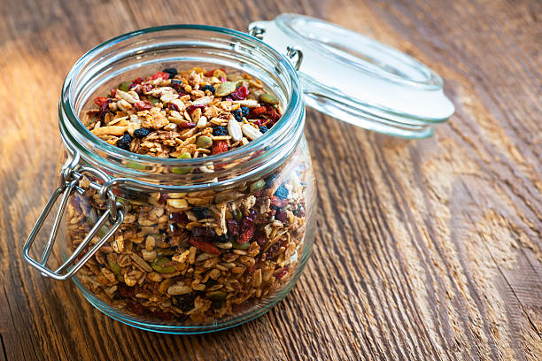 istock Homemade granola in open glass jar 511645695