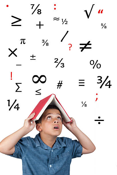 Young male student hiding under book with falling symbols stock photo
