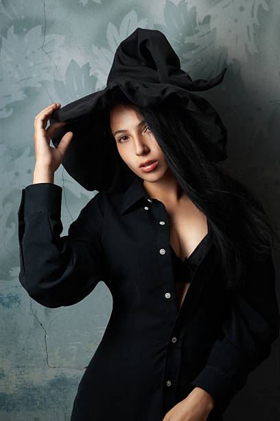 istock girl in a witch costume sexy looks 511646633