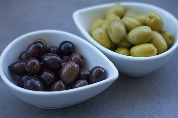 istock Green and black olives in ceramic pots 511647781