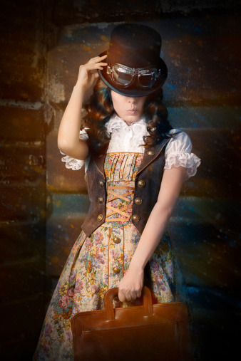 Portrait of a young woman wearing a steampunk outfit and holding a portfolio bag