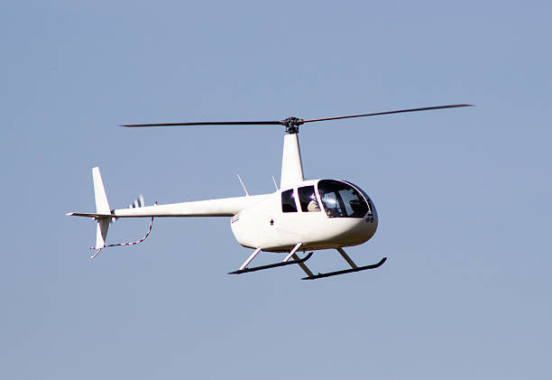 istock White rescue helicopter moving in blue sky 511649012