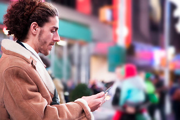 Man with cell phone in Times Square, New York City.