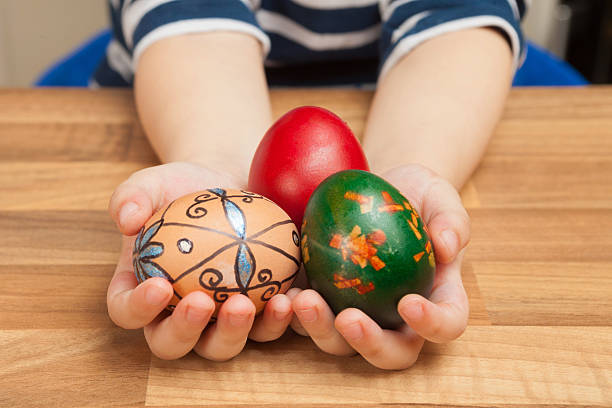 istock Easter eggs in hands of a child. 511650958