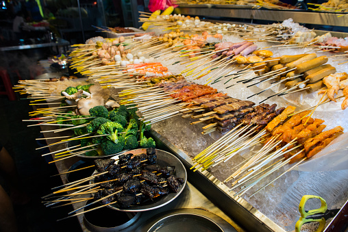 Asian food on skewers and workbench
