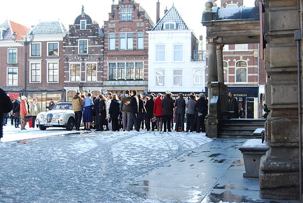 Delft (Netherlands) daily, snowy main square, people blue sky Delft, Netherlands - January 31, 2010: daily and snowy main square of Delft in the Netherlands in the morning with people and blue sky as lifestyle on January 31, 2010 in Delft, Netherlands as editorial delft winter netherlands snow stock pictures, royalty-free photos & images