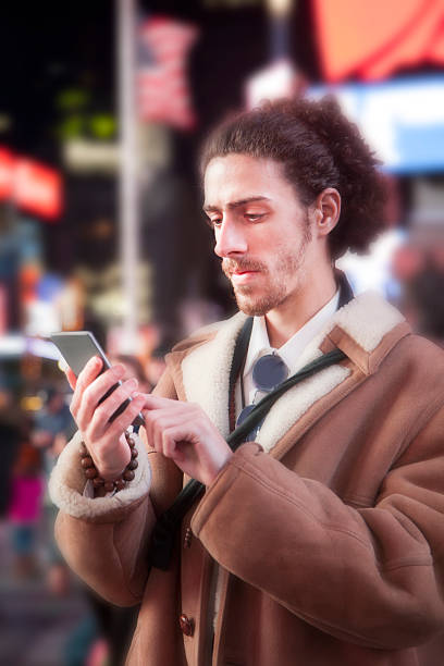 istock Man with cell phone in Times Square, New York City. 511653522