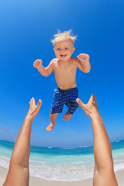 istock Father throwing up in the air a happy child 511654644