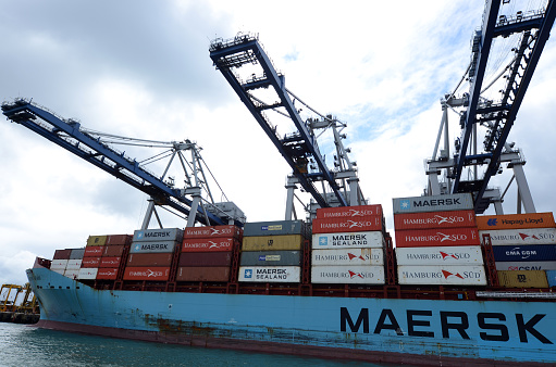 Auckland, New Zealand - October 13, 2015: Maersk Line cargo ship unloading containers in Ports of Auckland New Zealand. It is the world's largest container shipping company operates over 600 vessels worldwide.