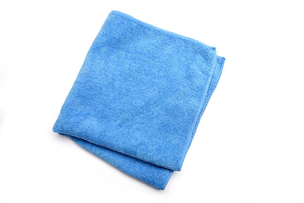 Microfiber cleaning cloth Folded blue microfiber cleaning cloth on a white background towel stock pictures, royalty-free photos & images