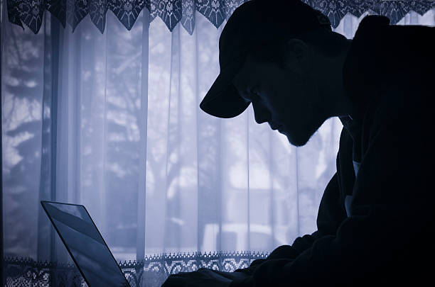 istock silhouette image of young man on his laptop. 511657068