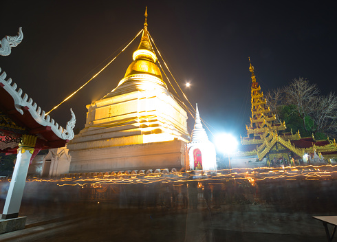 Makha Bucha Day, Candle lit from buddhists are moving around pagoda at Wat Phra Kaew Don Tao of lampang,Thailand