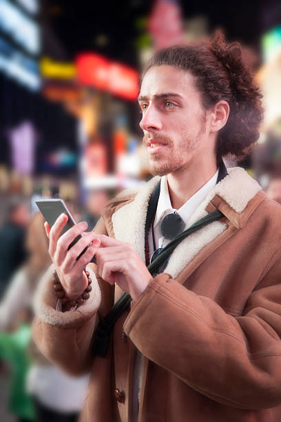istock Man with cell phone in Times Square, New York City. 511661812