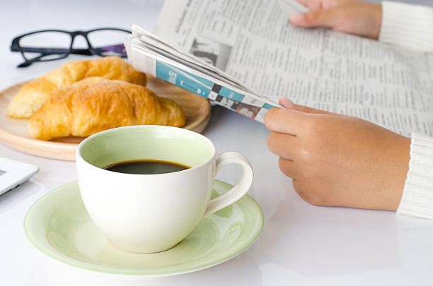 istock cup coffee on the desk and reading newspaper. 511662546