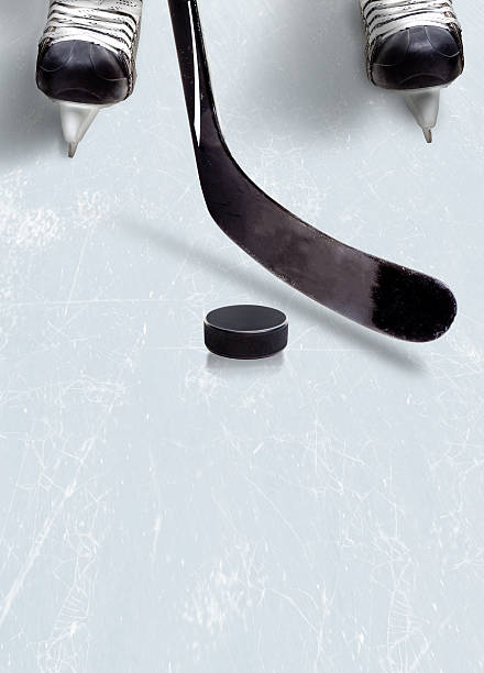 istock Ice hockey stick and puck on ice with copy space. 511662976