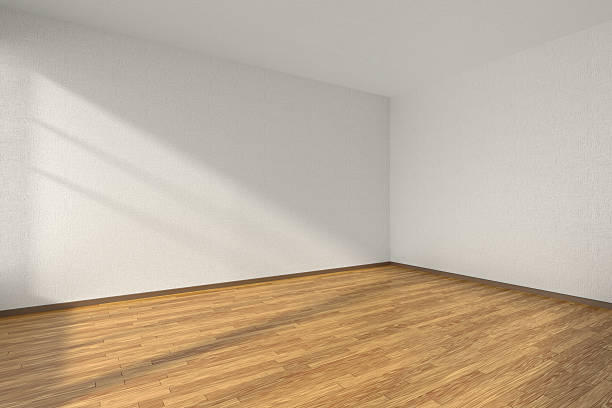 Empty room with parquet floor and textured white walls