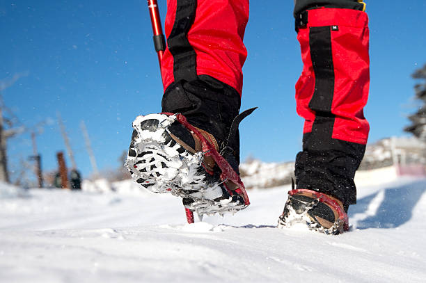 istock walking on snow with Snow shoes and Shoe spikes. 511666658