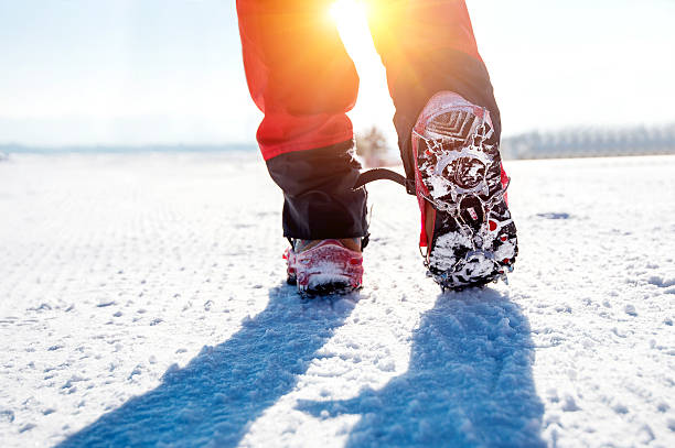 istock walking on snow with Snow shoes and Shoe spikes. 511666710