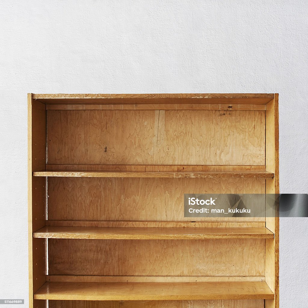 Wooden book Shelf Wooden book Shelf near the stucco wall background Blank Stock Photo