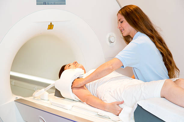 istock Medical technical assistant preparing scan of shoulder with MRI 511670801