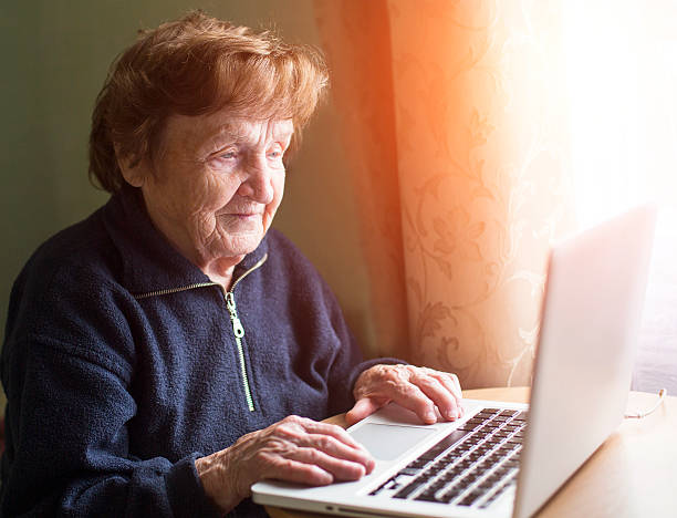 istock Old woman sing laptop computer at home. 511670885