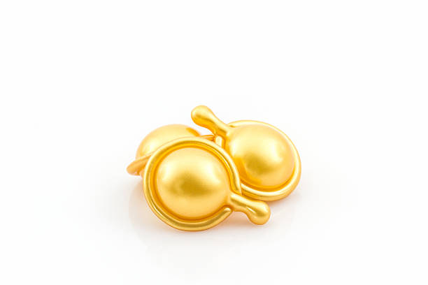istock Hair vitamin serum capsule gold color. 511673430