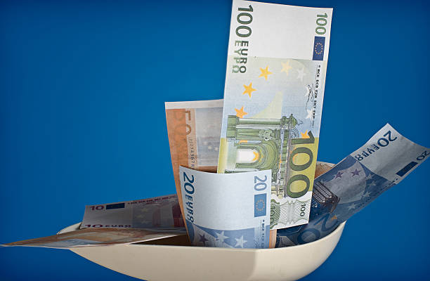 istock Euro banknotes in a meat grinder 511673880