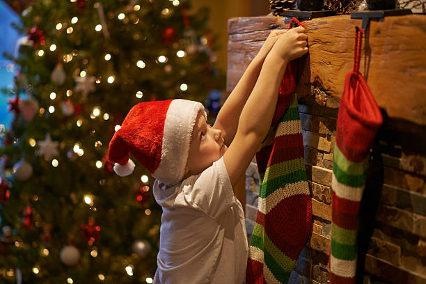 'Twas the night before Christmas Shot of a little boy hanging up Christmas stocking at homehttp://195.154.178.81/DATA/i_collage/pu/shoots/806373.jpg christmas stocking stock pictures, royalty-free photos & images