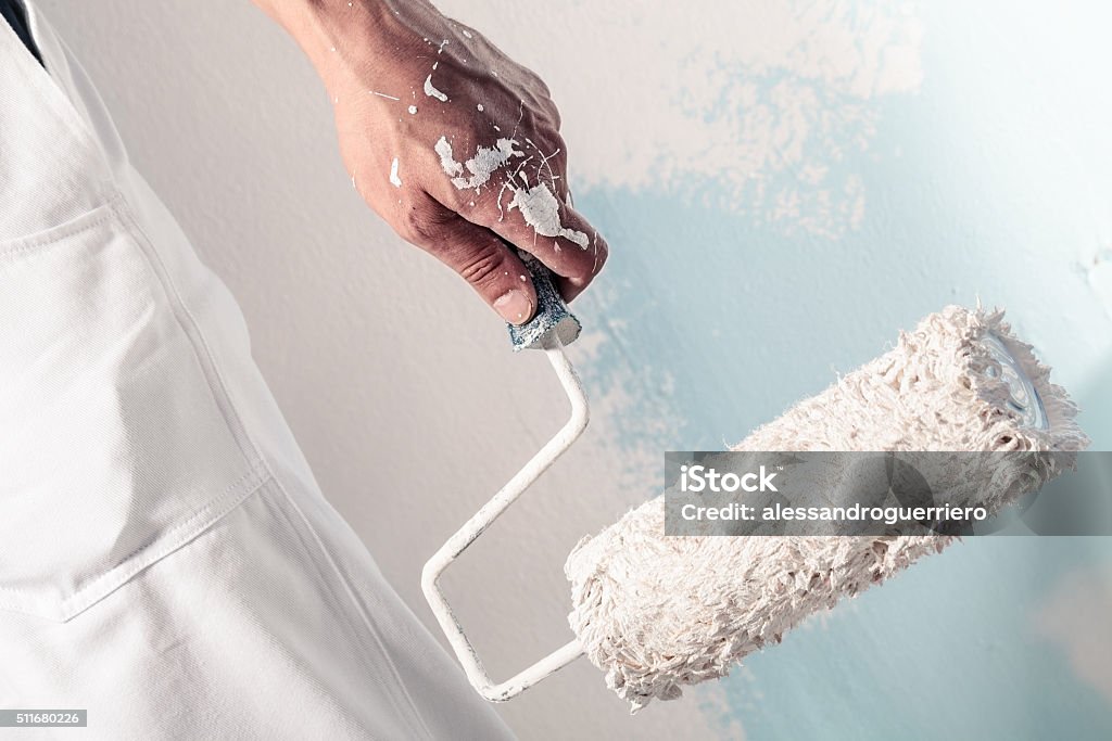 Workman Hand holding Dirty Paintroller Close up Of Professional Workman Hand holding Dirty Paintroller House Painter Stock Photo