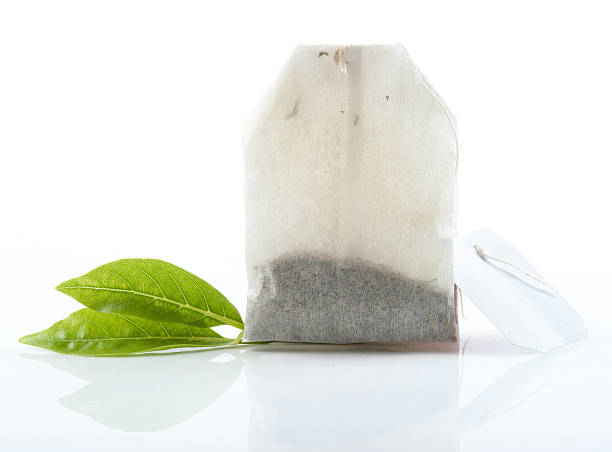 istock Tea bag with leaves isolated on white background 511707803