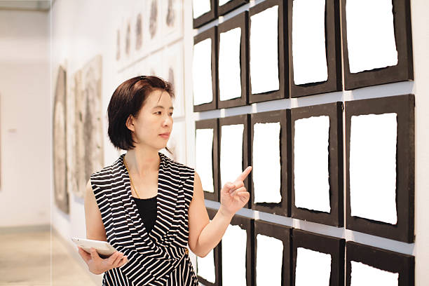 istock Woman looking at notice board in hall 511708291