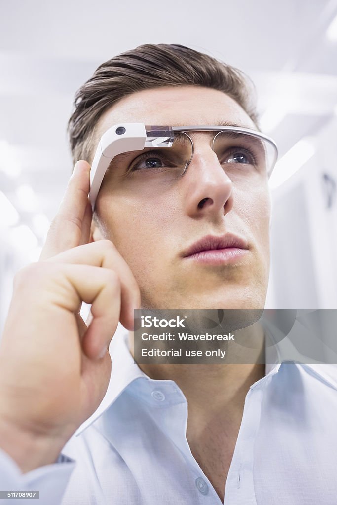 Businessman standing in the server room Cork, Ireland - June 6, 2014: Businessman standing in the server room wearing google glass Smart Glasses - Eyewear Stock Photo