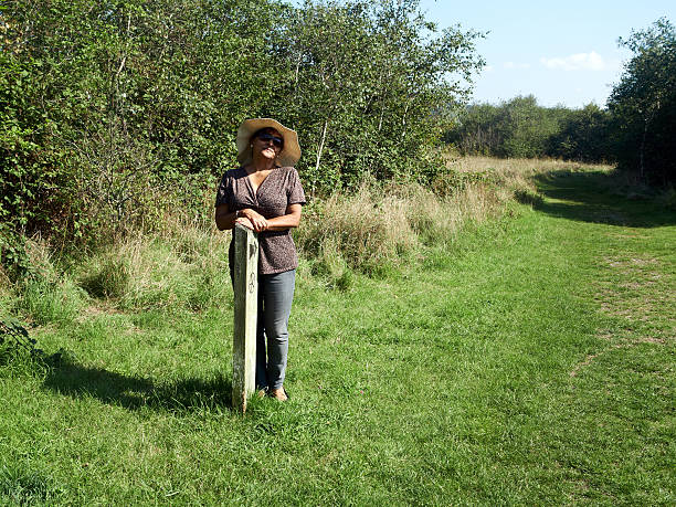 Mature smiling hispanic woman on countryside footpath