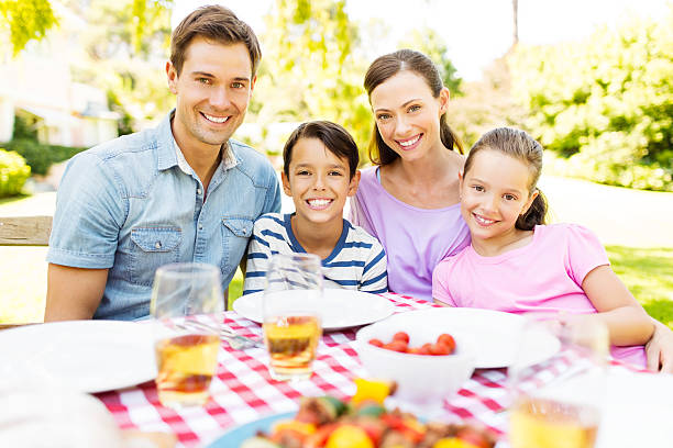 istock Happy Family Having Meal At Outdoor Table 511709209