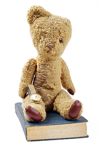 istock antique book watch and teddy bear 511709365
