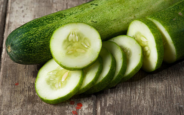 istock cucumber slices on wooden background 511711863