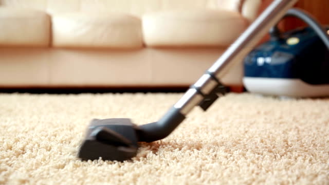Vacuum cleaner cleaning the carpet, dolly shot