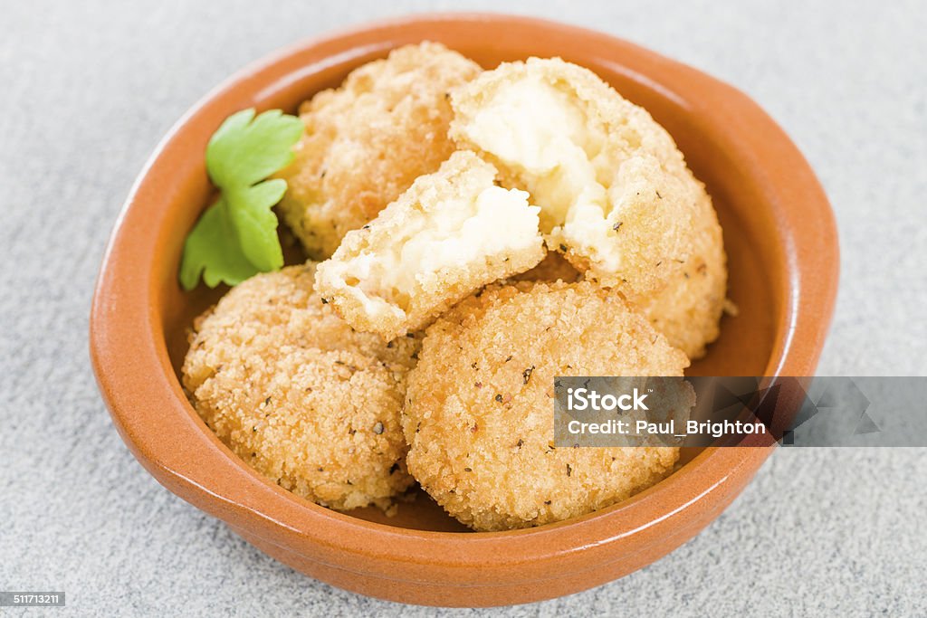 Deep Fried Cheese Balls Manchego cheese breaded and deep fried served in a cazuela. Cheese Stock Photo